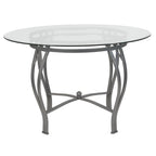 Mesa de comedor redonda de cristal con estructura metálica curvada