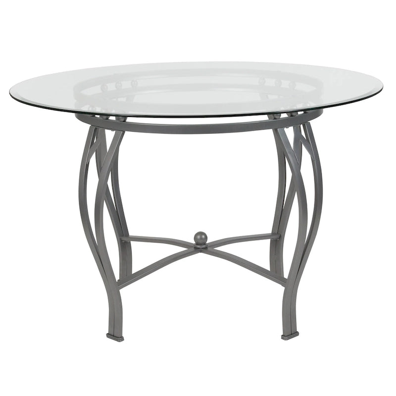 Mesa de comedor redonda de cristal con estructura metálica curvada