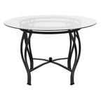 Mesa de comedor redonda de cristal con estructura metálica curvada
